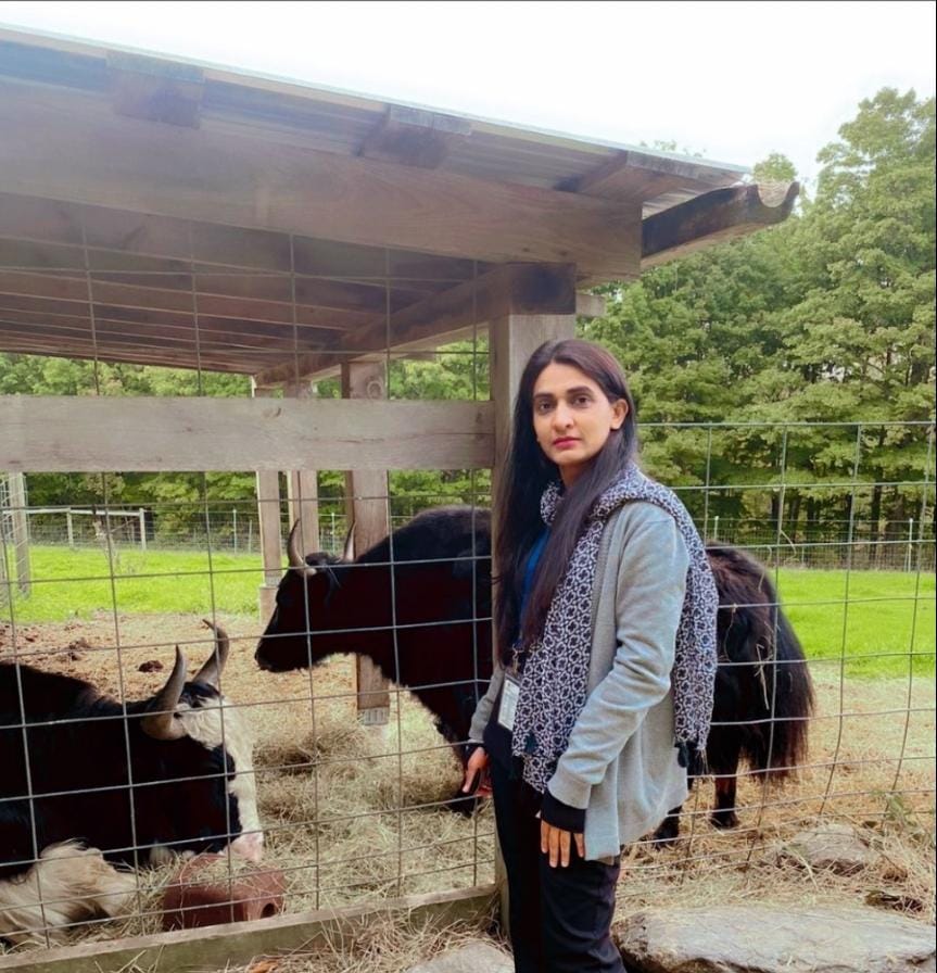 Dr. Arooma Maryam posing with cows