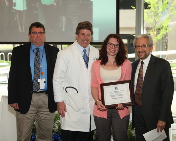 Stacey Willard accepts her award, presented by (from left) Shawn Cody, MD; Craig Lilly, MD; and Richard Irwin, MD.