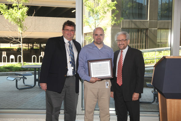 Outstanding Nurse Practitioner Student in Critical Care Award winner Michael Spiros with (from left) Shawn Cody and Richard Irwin, MD.