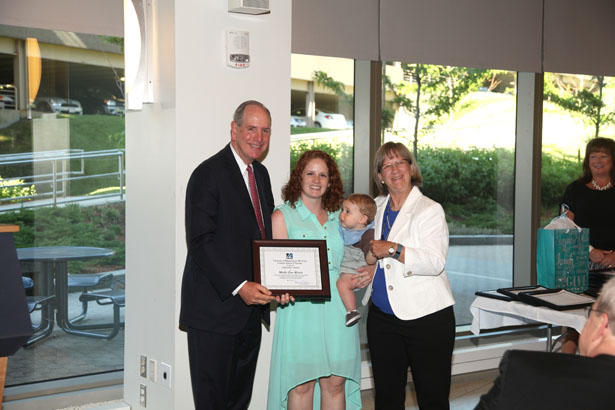 Molly Rivest accepts the Chancellor’s Award from Chancellor Collins and GSN Dean Paulette Seymour-Route.