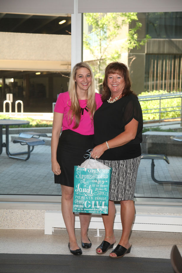 Nicole Coggins receives the Lucy D. Russell Briefcase Award from Jill Terrien, PhD.