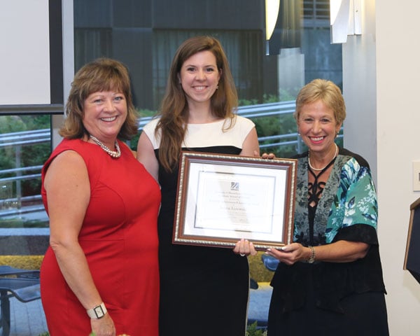 Jenna Lizewski accepts the Academic Achievement and Leadership Award from Jill Terrien, PhD, and Dean Vitello.