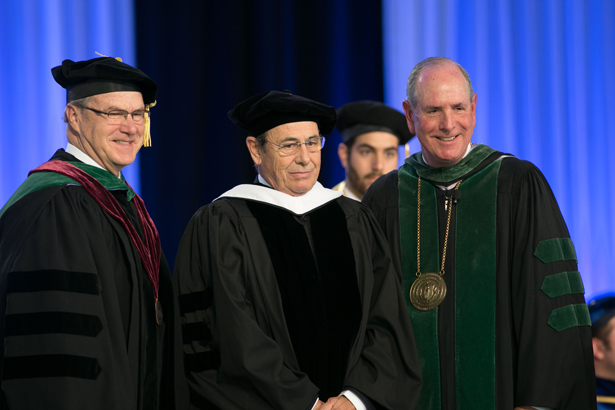 Dean Terence R. Flotte and Chancellor Collins present an honorary degree to Victor Grifols.