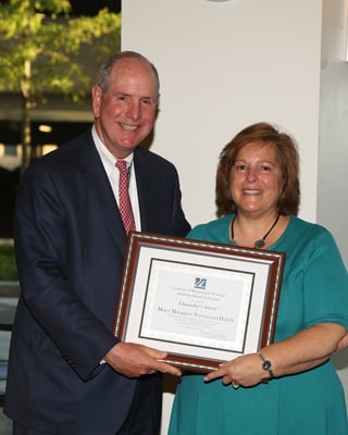 Chancellor Michael F. Collins presents the Chancellor’s Award for Excellence in Nursing to Mary Fortunato-Habib, MS, RN.