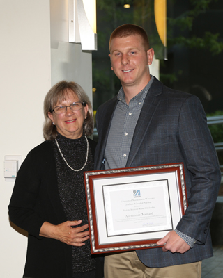 Dr. Seymour-Route awards the Paulette Seymour-Route Scholarship to Alexander Menard, MS, RN.