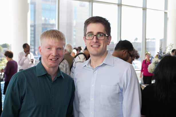 Nicholas Rice, from the Bill Theurkauf lab, and Michael Gallagher of the Leslie Berg lab, celebrate at the reception.