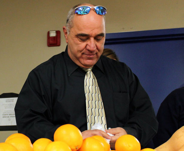UMass Chan Medical School staff member Bill Tsaknopoulos sorts through oranges before the Veterans Inc. Harvest Day event.