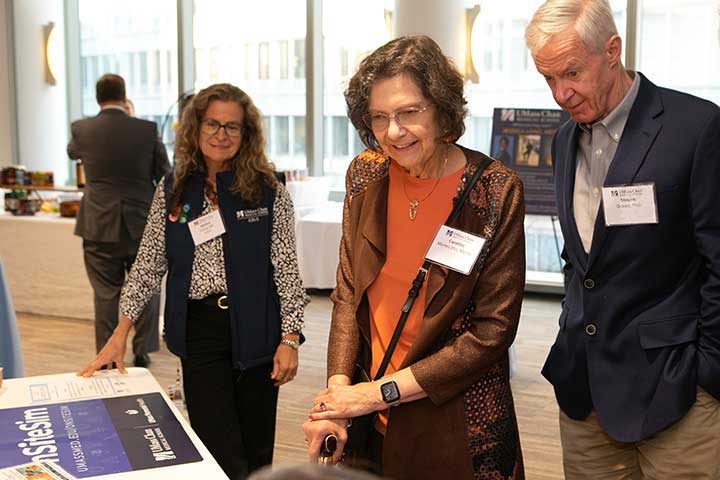 Caroline Marten-Ellis, MD’86, and Stephen Graves, PhD, enjoy a simulation display at the Scholarship Celebration event.