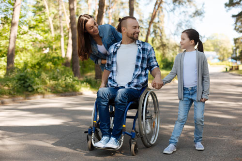 ALS impacts the whole family; family walking with father in wheelchair