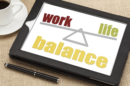 work life balance graphic on table next to cup of coffee