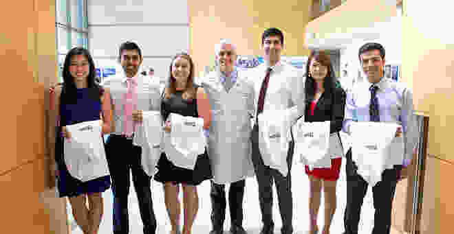 Medical students holding their white coats prior to the White Coat ceremony