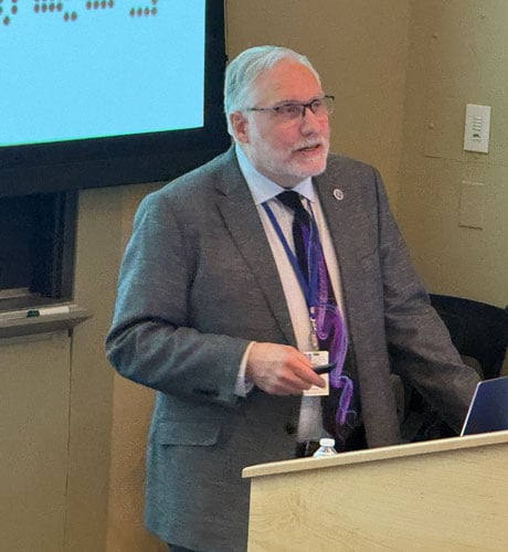 Sheldon Benjamin, MD, presenting at a podium