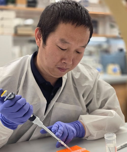 Dongsheng Guo, PhD, working with research specimens