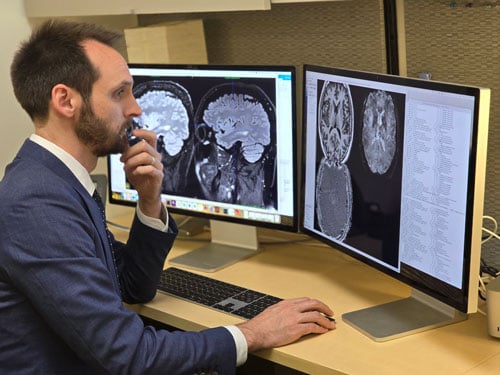 Christopher Hemond, MD, analyzing scans on the computer