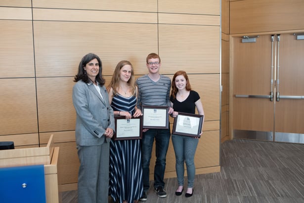 From left, Mary Ellen Lane, PhD, presents curriculum achievement awards to Gillian Griffith, Benjamin Landry and Janelle Hayes.