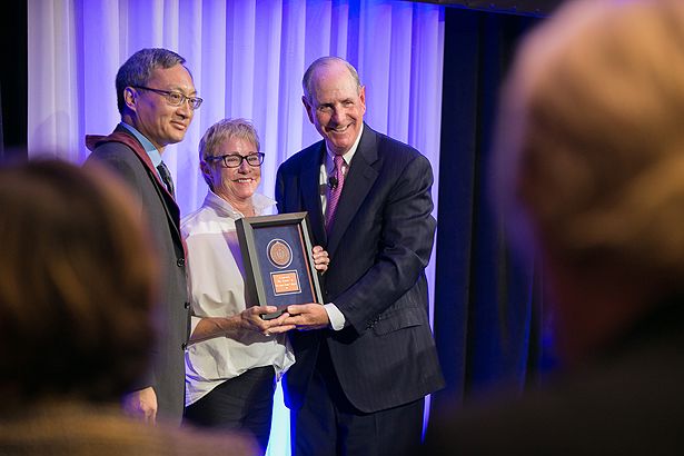 Chancellor Collins recognizes Jan Cellucci for her support of the Governor Paul Cellucci Chair in Neuroscience Research, held by Fen-Biao Gao (left).