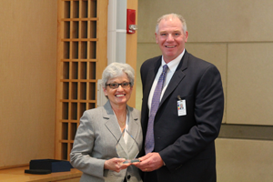 Sara Adams, LMHC, recipient of the Cultural Competence in Medicine Award, with presenter Eric Dickson, MD