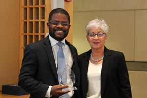 Josiah Bote accepts the Graduate Medical Education Reducing Health Care Disparities Award from Deborah DeMarco.