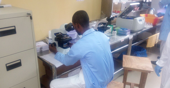 An employee works in the Tappita Hospital Lab in Nimba county Liberia