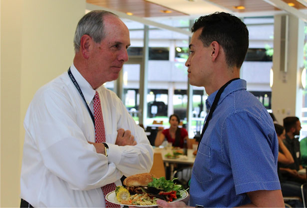 Chancellor Michael F. Collins greets second-year student Brooks Willar.