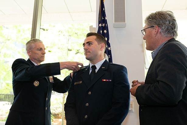 U.S. Air Force Lt. Maxwell Kruse is pinned by Brigadier Gen. Sean Collins and his father.