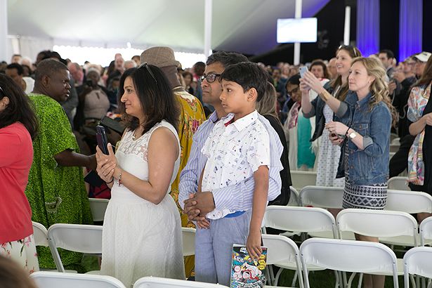 Family and friends await the graduates’ entrance inside the tent.