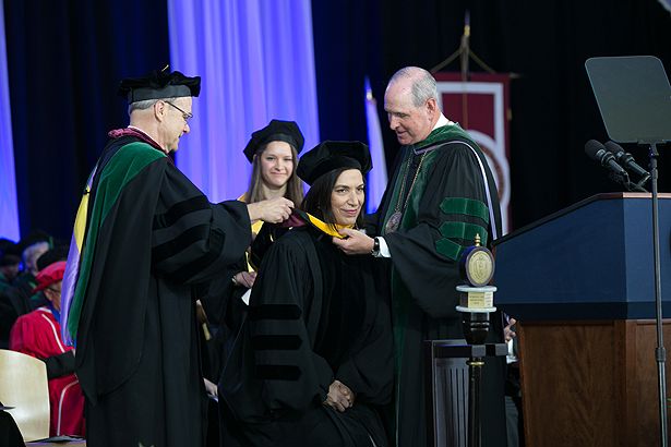 Dean Flotte and Chancellor Collins hood honorary degree recipient Huda Zoghbi