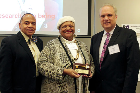 Worcester Major Joseph Petty (far right) presents a key to the city to Worcester Pipeline Collaborative Director Robert Layne, MEd, and founder Deborah Harmon-Hines, PhD.