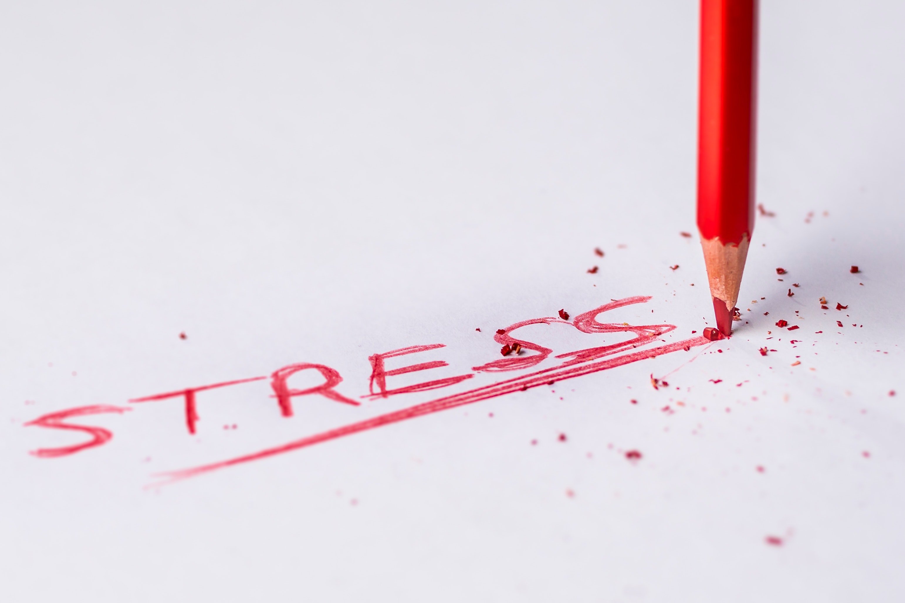 The word "Stress" in red with pencil breaking